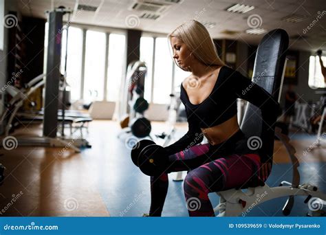 Girl Blonde Doing Exercises In The Gym Girl Goes In For Sports In The