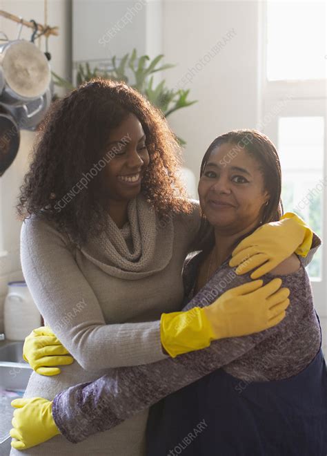 Mother And Daughter In Rubber Cleaning Gloves Hugging Stock Image
