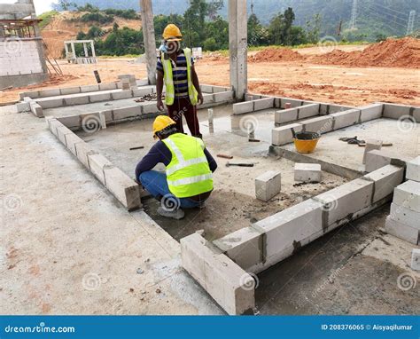 Construction Workers Laying Autoclaved Aerated Concrete Block At The