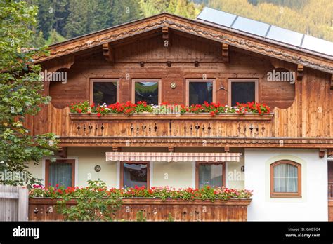 Traditional Austrian Houses With Flowers In Windows In Tux Zillertal