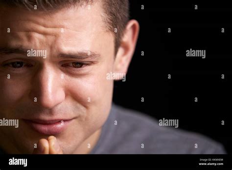 Close Up Of Crying Young White Man Looking Down Horizontal Stock Photo