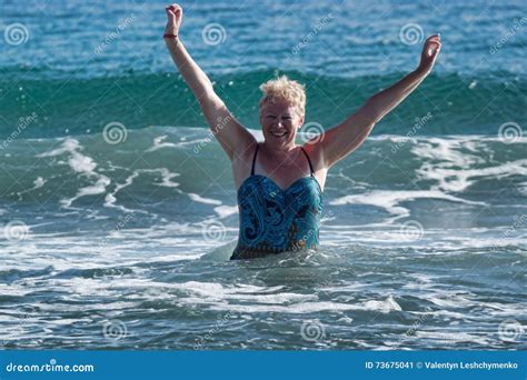a woman of mature age in a swimsuit stock image image of beach arms 73675041