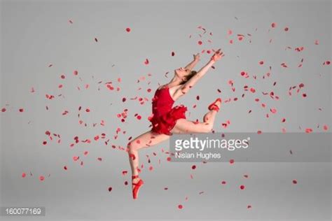 Stock Photo Ballerina Jumping Through Red Flowers Petals Canvas Print