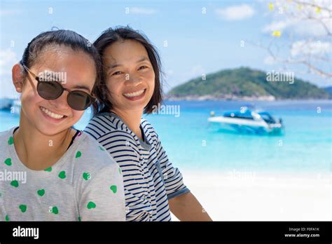 Female Tourists Mother And Daughter Smiling Happily On The Beach At Koh