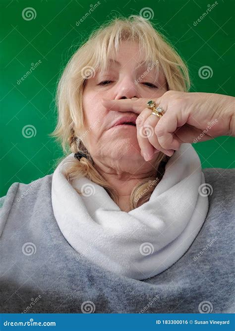 Senior Woman With Finger Under Nose Runny Nose Or Sneeze Touching