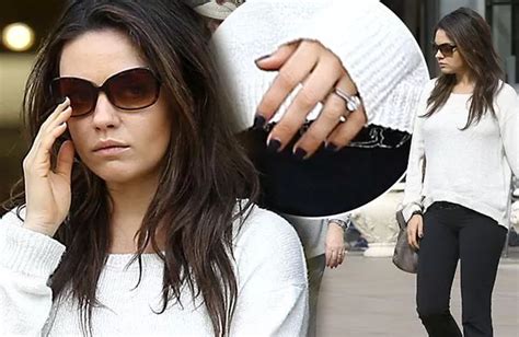 Mila Kunis flashes THAT ring again as she shares a sneaky kiss with rumoured fiancé Ashton