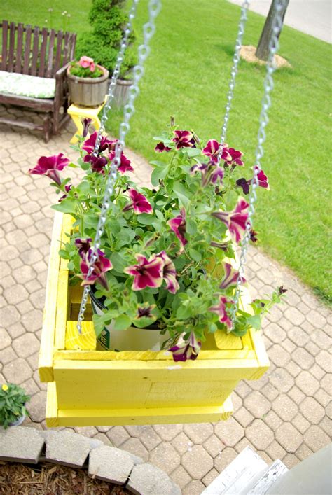 Hang this metal planter from a porch or fence to display a bouquet of beautiful flowers or convenient herbs. DIY Wood Pallet Hanging Planter