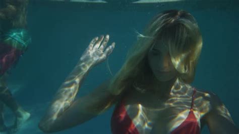 Slow Motion Underwater Close Up Of Woman Floating In Pool