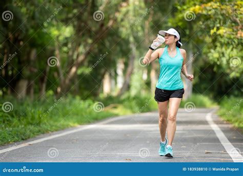 Healthy Woman Jogging Run And Workout And Drink Fresh Water On Road