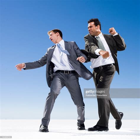 Two Businessmen In A Fist Fight High Res Stock Photo