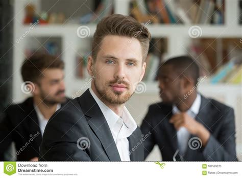 Young Serious Businessman Looking At Camera On Meeting Headshot Stock