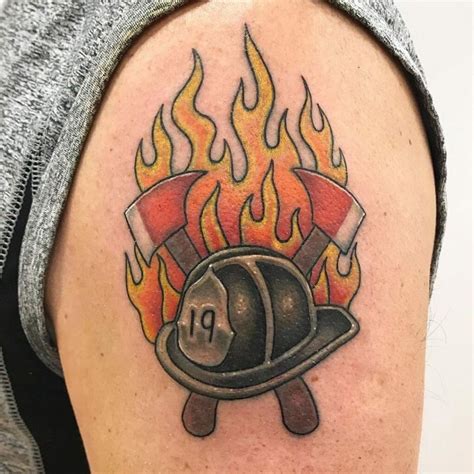 A Firefighters Helmet With Flames On The Back Of His Arm Is Shown