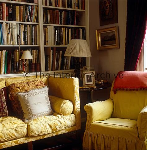 Interior design yellow armchair on blue wall. A yellow damask sofa and a comfortable matching armchair ...