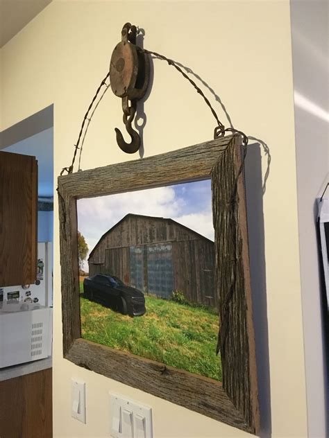 What makes barnwood rustics so different? An old barn pulley some barb wire & barn wood and there ...