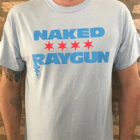 Naked Raygun Chicago On Front Flag On Sleeve On A Light Blue Shirt