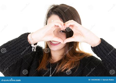 Isolated Portrait Of Beautiful Caucasian Woman Make Heart Symbol By Hands On Face Stock Image