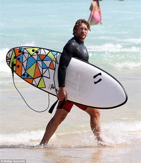 Simon Baker Hits The Waves On His Surfboard Before Revealing His Manly