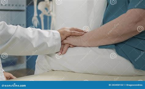 Physician Showing Compassion To Old Patient at Appointment Stock Photo