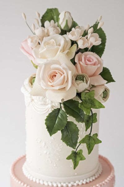 Realistic Sugar Flowers On A Wedding Cake Designed For A Couple Getting
