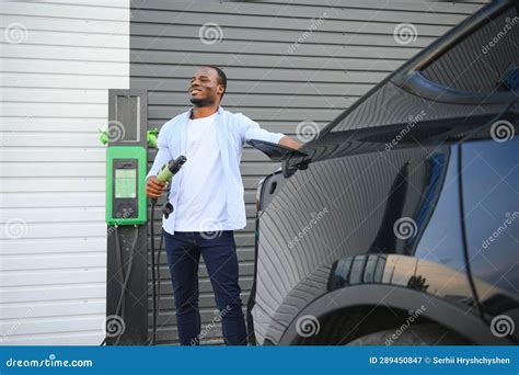 African American Man Charging His Electric Car Stock Image Image Of