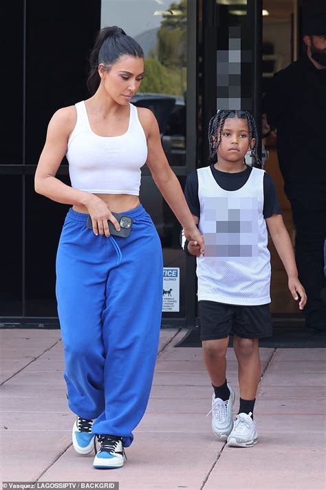 Kim Kardashian Shows Off Tiny Waist In Crop Top And Sweats As She Holds