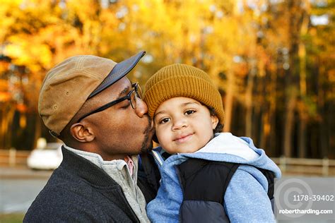 Father Kissing Son On Cheek Stock Photo