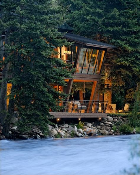 River House Glows Like A Lantern In The Woods Rustic Exterior