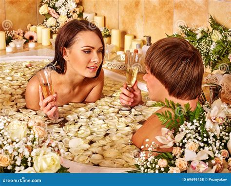 Couple Relaxes In The Bath With Flower Petals Spa Center Stock Photo Image Of Health Body
