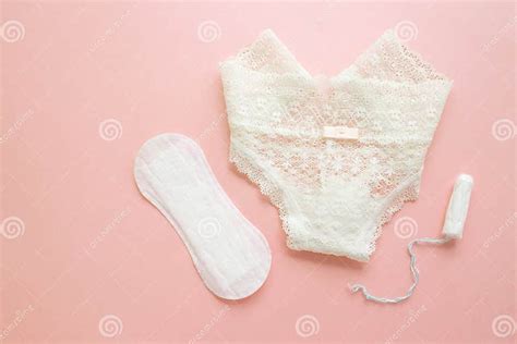 women intimate hygiene products sanitary pads and tampon near womans panties on pink