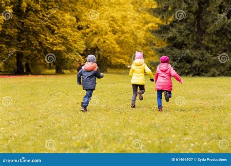 Group Of Happy Little Kids Running Outdoors Stock Image Image Of Park
