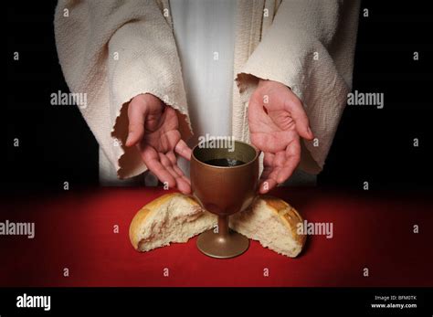 The Hands Of Jesus Offering The Communion Wine And Bread Stock Photo