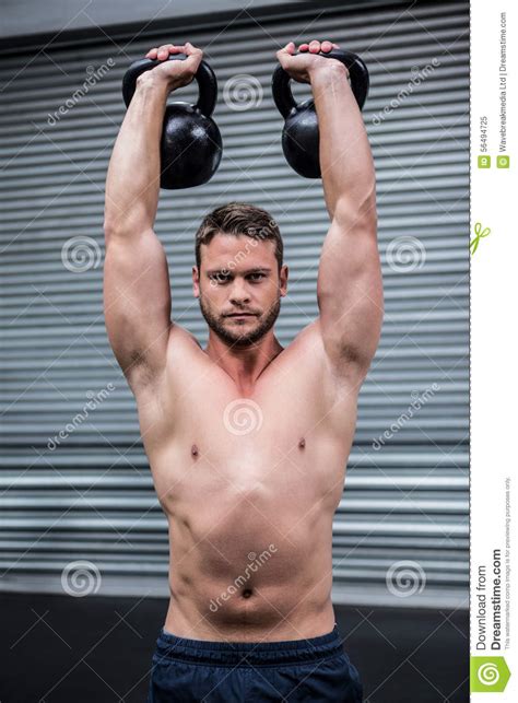 Portrait Of Muscular Man Lifting Two Kettlebells Stock Image Image Of