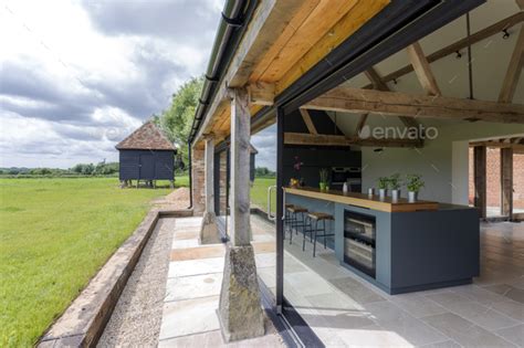 Open Air Kitchen And Backyard In Modern Home Stock Photo By Mintimages