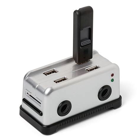 A Silver And Black Toaster Sitting On Top Of A White Table