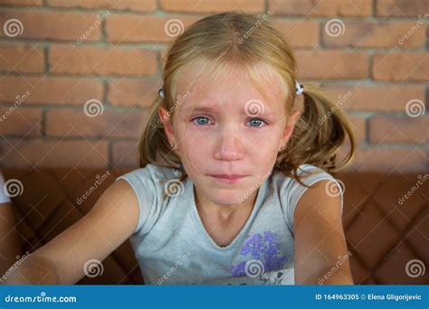 Little Blond Crying Girl With Sad Expression And Tears Stock Image