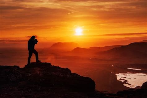 Premium Photo Happy Man Standing On A Cliff At Sunset
