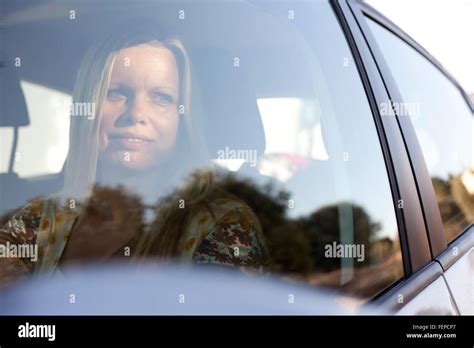 Mature Woman Inside Car Looking Through Window Stock Photo Alamy