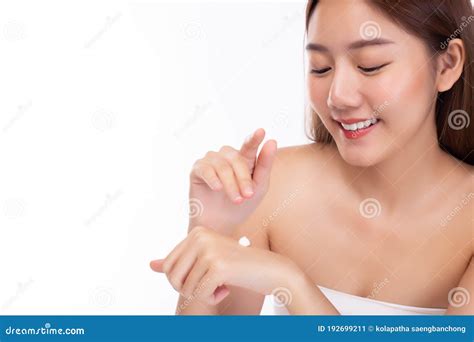 beautiful asian woman apply body lotion or sunscreen lotion to hand for apply to face and body