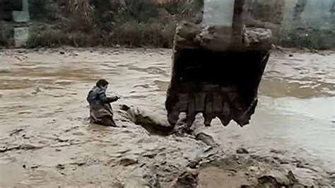 Excavator Rescues Man Trapped In Mud Video