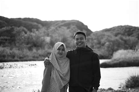 Premium Photo A Man And A Woman Standing In Front Of A River