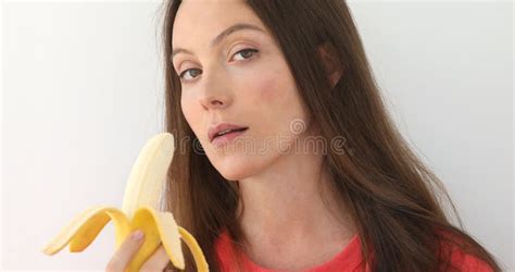 Attractive Woman Peeling And Eating A Big Banana Stock Image Image Of Caucasian Background