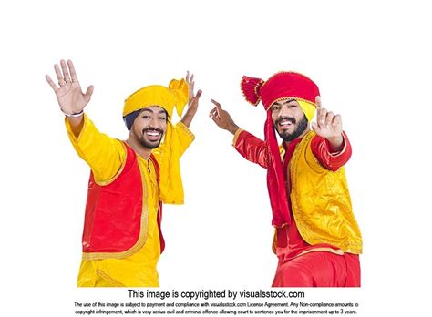 Two Punjabi Men In Traditional Clothing Doing Bhangra Folk Dance On