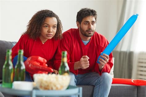 Premium Photo Portrait Of Modern Mixed Race Couple Watching Sports On