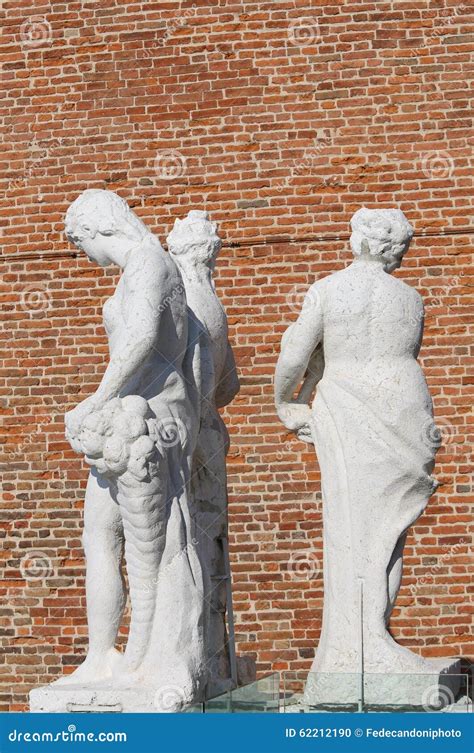 Ancient Statues With The Background Red Brick Wall Stock Photo Image