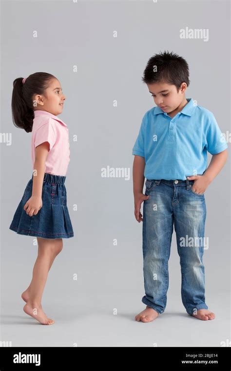 Girl Trying To Be Taller Than Her Brother Stock Photo Alamy