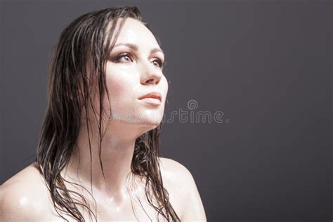 Portrait Of Caucasian Sensual Brunette Girl Showing Wet And Shining Skin And Wet Hair Stock