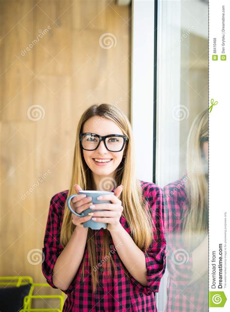 And aw, we sit like watchmen. Young Freelance Lady Drinking Coffee In Casual Clothes And Looking At Camera Near A Window ...