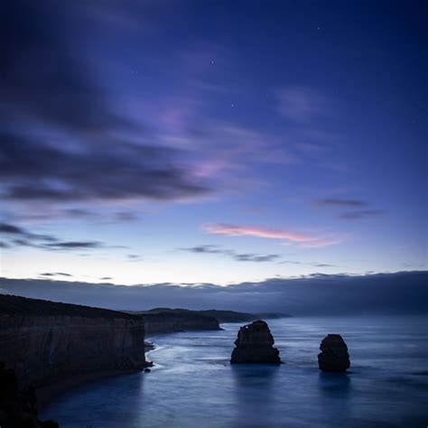 Download Wallpaper 2780x2780 Sea Rocks Cliff Twilight Landscape
