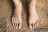 Close-up of male feet standing on ground — daytime, leisure - Stock ...