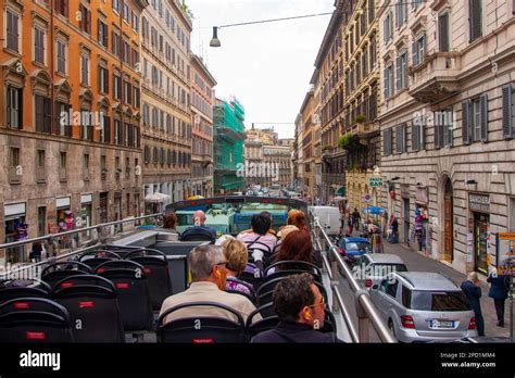 Tourists Sightseeing City On A Hop On Hop Off Double Decker Tour Bus In